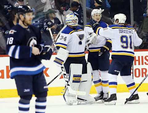 Dec 15, 2015; Winnipeg, Manitoba, CAN; St. Louis Blues goalie Jake Allen (34) celebrates with teammates after the third period against the Winnipeg Jets at MTS Centre. St. Louis Blues wins 4-3. Mandatory Credit: Bruce Fedyck-USA TODAY Sports