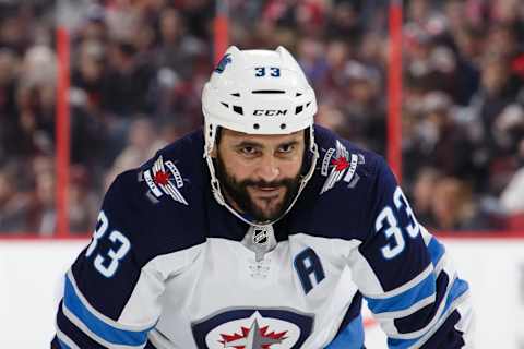 Dustin Byfuglien of the Winnipeg Jets looks on during a face-off against the Ottawa Senators at Canadian Tire Centre on February 9, 2019.