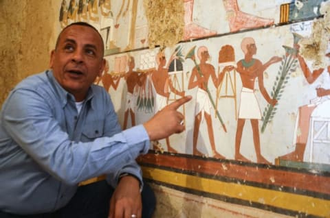 Mustafa al-Waziri, director general of Luxor's Antiquities, points at an ancient Egyptian mural found at the newly discovered 'Kampp 161' tomb at Draa Abul Naga necropolis on the west Nile bank of the southern Egyptian city of Luxor, about 400 miles south of the capital Cairo, on December 9, 2017.