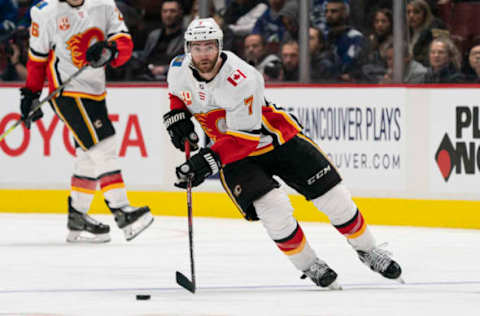 VANCOUVER, BC – FEBRUARY 08: T.J. Brodie #7 of the Calgary Flames skates with the puck in NHL action against the Vancouver Canucks at Rogers Arena on February 8, 2020 in Vancouver, Canada. (Photo by Rich Lam/Getty Images)