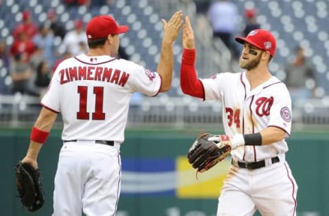 Jun 2, 2015; Washington, DC, USA; Washington Nationals first baseman Zimmerman (11) and right fielder Harper (34) celebrate after the game against the Toronto Blue Jays in game one of a double header at Nationals Park. The Washington Nationals won 2-0. Mandatory Credit: Brad Mills-USA TODAY Sports