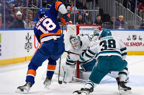 Dec 5, 2023; Elmont, New York, USA; San Jose Sharks goaltender Kaapo Kahkonen (36) blocks the shot by New York Islanders left wing Pierre Engvall (18) during the second period at UBS Arena. Mandatory Credit: Dennis Schneidler-USA TODAY Sports