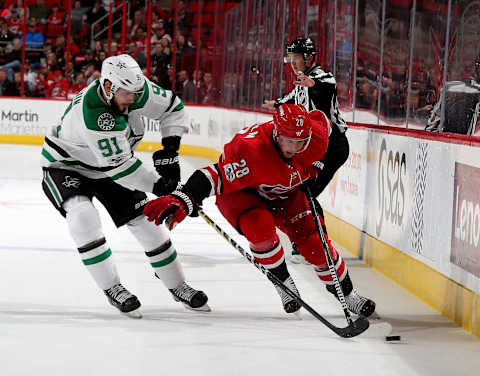 RALEIGH, NC – NOVEMBER 13: Elias Lindholm #28 of the Carolina Hurricanes controls the puck along the boards away from Tyler Sequin #91 of the Dallas Stars during an NHL game on November 13, 2017 at PNC Arena in Raleigh, North Carolina. (Photo by Gregg Forwerck/NHLI via Getty Images)