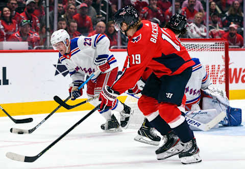 WASHINGTON, DC – OCTOBER 18: New York Rangers defenseman Adam Fox (23) skates against Washington Capitals center Nicklas Backstrom (19) on October 18, 2019, at the Capital One Arena in Washington, D.C. (Photo by Mark Goldman/Icon Sportswire via Getty Images)