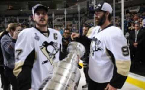 Jun 12, 2016; San Jose, CA, USA; Pittsburgh Penguins center Sidney Crosby (87) and teammate Pascal Dupuis (9) with the Stanley Cup after defeating the San Jose Sharks in game six of the 2016 Stanley Cup Final at SAP Center at San Jose. Mandatory Credit: Gary A. Vasquez-USA TODAY Sports