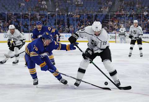 Mar 6, 2022; Buffalo, New York, USA; Los Angeles Kings left wing Alex Iafallo (19) looks to control the puck as Buffalo Sabres defenseman Jacob Bryson (78) defends during the first period at KeyBank Center. Mandatory Credit: Timothy T. Ludwig-USA TODAY Sports