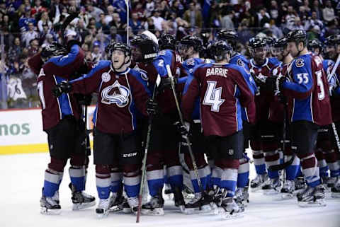 Dec 7, 2015; Denver, CO, USA; Members of the Colorado Avalanche celebrate the overtime win against the Minnesota Wild at Pepsi Center. The Colorado Avalanche defeated the Minnesota Wild 2-1 in overtime. Mandatory Credit: Ron Chenoy-USA TODAY Sports