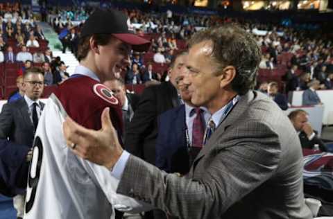 VANCOUVER, BRITISH COLUMBIA – JUNE 22: Drew Helleson, 47th overall pick of the Colorado Avalanche, is greeted at the team draft table by general manager Joe Sakic during Rounds 2-7 of the 2019 NHL Draft at Rogers Arena on June 22, 2019 in Vancouver, Canada. (Photo by Dave Sandford/NHLI via Getty Images)