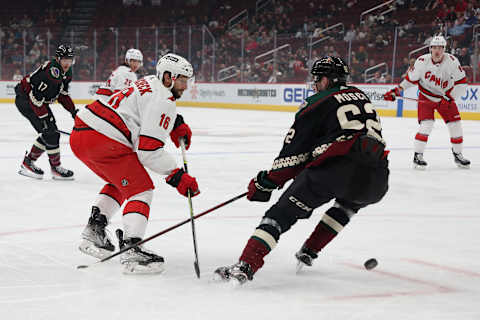 GLENDALE, ARIZONA – APRIL 18: Vincent Trocheck #16 of the Carolina Hurricanes attempts to control the puck under pressure from J.J. Moser #62 of the Arizona Coyotes during the first period of the NHL game at Gila River Arena on April 18, 2022 in Glendale, Arizona. (Photo by Christian Petersen/Getty Images)