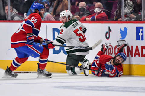 MONTREAL, QC – APRIL 19: David Savard #58 of the Montreal Canadiens crashes into the boards as he skates against Connor Dewar #52 of the Minnesota Wild during the third period at Centre Bell on April 19, 2022 in Montreal, Canada. The Minnesota Wild defeated the Montreal Canadiens 2-0. (Photo by Minas Panagiotakis/Getty Images)