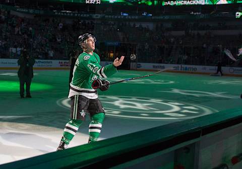 Mar 24, 2017; Dallas, TX, USA; Dallas Stars right wing Adam Cracknell (27) throws a puck to the crowd after the win over the San Jose Sharks at the American Airlines Center. Cracknell scores his first career NHL hat trick. The Stars defeat the Sharks 6-1. Mandatory Credit: Jerome Miron-USA TODAY Sports