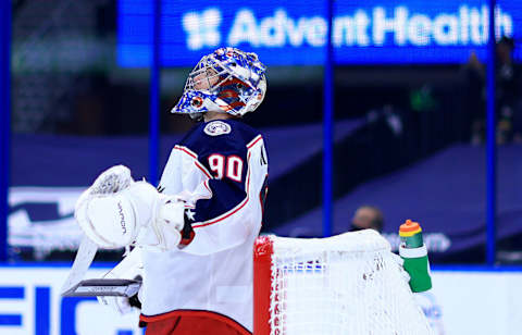 TAMPA, FLORIDA – APRIL 01: Elvis Merzlikins #90 of the Columbus Blue Jackets looks on during a game against the Tampa Bay Lightning at Amalie Arena on April 01, 2021 in Tampa, Florida. (Photo by Mike Ehrmann/Getty Images)