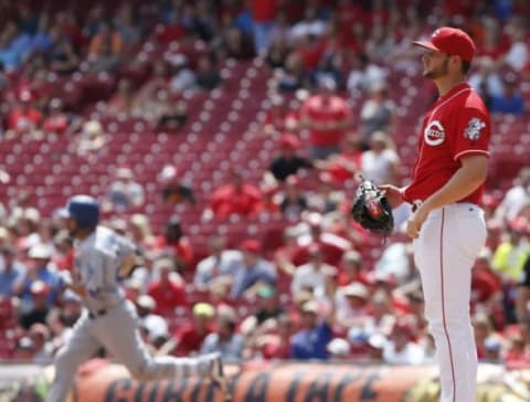 Aug 22, 2016; Cincinnati, OH, USA; Cincinnati Reds relief pitcher Josh Smith (right) stands at the mound as Los Angeles Dodgers third baseman Rob Segedin (left) rounds the bases after hitting a solo home run during the fifth inning at Great American Ball Park. Mandatory Credit: David Kohl-USA TODAY Sports