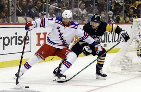 May 9, 2022; Pittsburgh, Pennsylvania, USA; New York Rangers center Kevin Rooney (17) reaches for the puck against pressure from Pittsburgh Penguins defenseman Chad Ruhwedel (2) during the third period in game four of the first round of the 2022 Stanley Cup Playoffs at PPG Paints Arena. The Penguins won 7-2. Mandatory Credit: Charles LeClaire-USA TODAY Sports