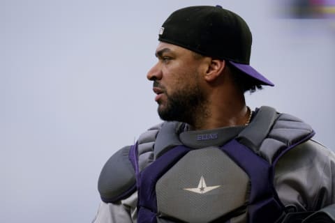 Jun 20, 2023; Cincinnati, Ohio, USA; Colorado Rockies catcher Elias Diaz (35) returns to the dugout after a mound visit in the second inning against the Cincinnati Reds at Great American Ball Park. Mandatory Credit: Sam Greene-USA TODAY Sports