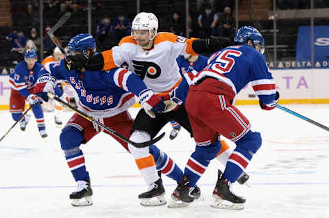 Scott Laughton #21 of the Philadelphia Flyers attempts to get past Brett Howden #21 and Libor Hajek #25 of the New York Rangers (Photo by Bruce Bennett/Getty Images)