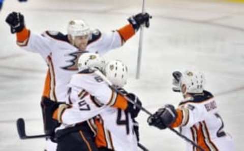 Apr 20, 2015; Winnipeg, Manitoba, CAN; Anaheim Ducks center Rickard Rakell (67) celebrates after he scores with teammates Andrew Cogliano (7), Francois Beauchemin (23) and Hampus Lindholm (47) during the overtime period in game three of the first round of the 2015 Stanley Cup Playoffs at MTS Centre. Anaheim Ducks win 5-4. Mandatory Credit: Bruce Fedyck-USA TODAY Sports