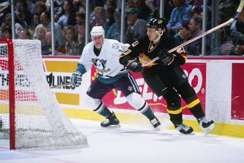 23 Feb 1997: Defenseman Jyrki Lumme of the Vancouver Canucks (right) and Anaheim Mighty Ducks rightwinger Joe Sacco tangle up during a game at Arrowhead Pond in Anaheim, California. The Ducks won the game, 5-2. Mandatory Credit: Elsa Hasch /Allsport