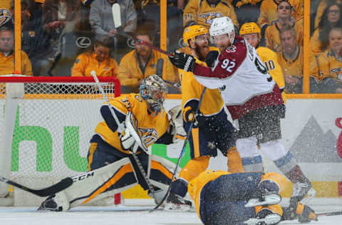 NASHVILLE, TN – APRIL 20: Gabriel Landeskog #92 of the Colorado Avalanche pushes Ryan Ellis #4 into goalie Pekka Rinne #35 creating a scoring chance during the third period of a 2-1 Avalanche victory in Game Five of the Western Conference First Round during the 2018 NHL Stanley Cup Playoffs at Bridgestone Arena on April 20, 2018 in Nashville, Tennessee. (Photo by Frederick Breedon/Getty Images)