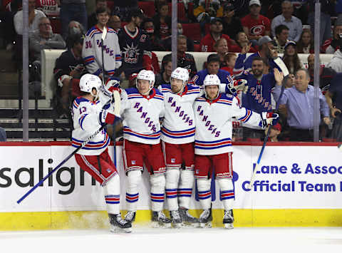 RALEIGH, NORTH CAROLINA – MAY 18: Filip Chytil #72 of the New York Rangers (2nd from right) celebrates his goal against the Carolina Hurricanes at 7:07 of the first period and is joined by (L-R) Alexis Lafreniere #13, Kaapo Kakko #24 and Adam Fox #23 in Game One of the Second Round of the 2022 Stanley Cup Playoffs at PNC Arena on May 18, 2022 in Raleigh, North Carolina. (Photo by Bruce Bennett/Getty Images)