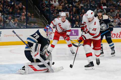 Oct 24, 2019; Columbus, OH, USA; Columbus Blue Jackets goalie Joonas Korpisalo (70) makes a save against Carolina Hurricanes center Sebastian Aho (20) during the third period at Nationwide Arena. Mandatory Credit: Russell LaBounty-USA TODAY Sports