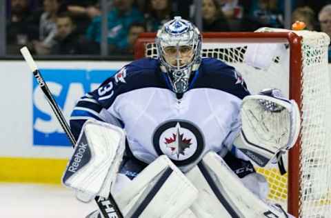 Apr 7, 2016; San Jose, CA, USA; Winnipeg Jets goalie Ondrej Pavelec (31) defends goal against a shot by the San Jose Sharks in the second period at SAP Center at San Jose. Winnipeg won 5-4. Mandatory Credit: John Hefti-USA TODAY Sports