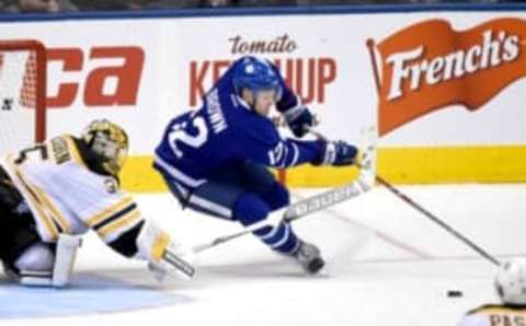 Oct 15, 2016; Toronto, Ontario, CAN; Toronto Maple Leafs forward Connor Brown (12) reaches for the puck as Boston Bruin goalie Anton Khudobin (35) defends in the second period at Air Canada Centre. Mandatory Credit: Dan Hamilton-USA TODAY Sports