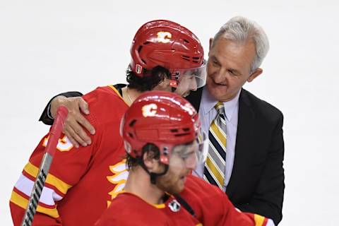 May 15, 2022; Calgary, Alberta, CAN; Calgary Flames head coach Darryl Sutter and forward Johnny Gaudreau (13) after beating the Dallas Stars in game seven of the first round of the 2022 Stanley Cup Playoffs at Scotiabank Saddledome. Mandatory Credit: Candice Ward-USA TODAY Sports