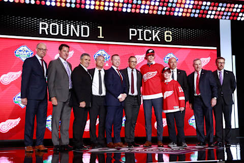 VANCOUVER, BRITISH COLUMBIA – JUNE 21: Moritz Seider (fifth from right), sixth overall pick of the Detroit Red Wings, pose for a group photo onstage with team personnel during the first round of the 2019 NHL Draft at Rogers Arena on June 21, 2019 in Vancouver, Canada. (Photo by Jeff Vinnick/NHLI via Getty Images)