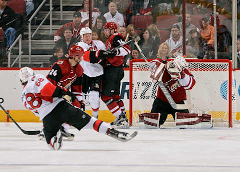 GLENDALE, AZ – NOVEMBER 28: Goaltender Anders Lindback #29 of the Arizona Coyotes makes a save on the shot by Mike Hoffman #68 of the Ottawa Senators as Chris Neil #25 of the Senators and Klas Dahlbeck #34 of the Coyotes battle in front of the net during the second period at Gila River Arena on November 28, 2015 in Glendale, Arizona. (Photo by Norm Hall/NHLI via Getty Images)