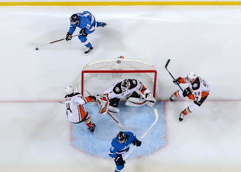 WINNIPEG, MB – FEBRUARY 2: Cam Fowler #4, goaltender Chad Johnson #1 and Josh Manson #42 of the Anaheim Ducks guard the goal as Bryan Little #18 of the Winnipeg Jets plays the puck behind the net during second period action at the Bell MTS Place on February 2, 2019 in Winnipeg, Manitoba, Canada. The Jets defeated the Ducks 9-3. (Photo by Jonathan Kozub/NHLI via Getty Images)