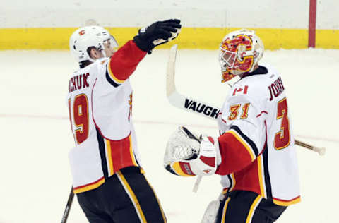 NHL Power Rankings: Calgary Flames left wing Matthew Tkachuk (19) and goalie Chad Johnson (31) celebrate after defeating the Pittsburgh Penguins at the PPG PAINTS Arena. Calgary won 3-2 in a shootout. Mandatory Credit: Charles LeClaire-USA TODAY Sports