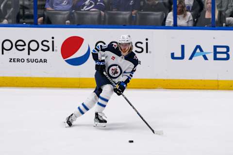 Mar 12, 2023; Tampa, Florida, USA; Winnipeg Jets left wing Kyle Connor (81) passes the puck during the second period against Tampa Bay Lightning at Amalie Arena. Mandatory Credit: Morgan Tencza-USA TODAY Sports