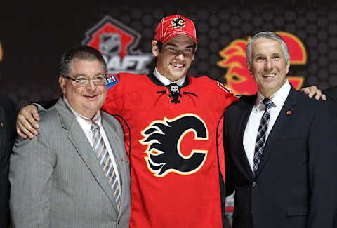 Jun 30, 2013; Newark, NJ, USA; Sean Monahan poses with team officials after being introduced as the number six overall pick to the Calgary Flames during the 2013 NHL Draft at the Prudential Center. Mandatory Credit: Ed Mulholland-USA TODAY Sports