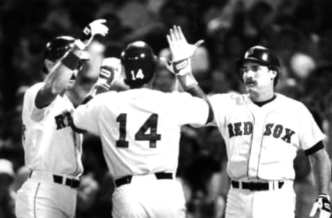 BOSTON, MA – JULY 21: Boston Red Sox player Jim Rice, center, is congratulated by teammates Dwight Evans and Wade Boggs after hitting a two-run home run in the fourth inning during a game against the California Angels at Fenway Park in Boston on Jul. 21, 1987. (Photo by Bill Brett/The Boston Globe via Getty Images)