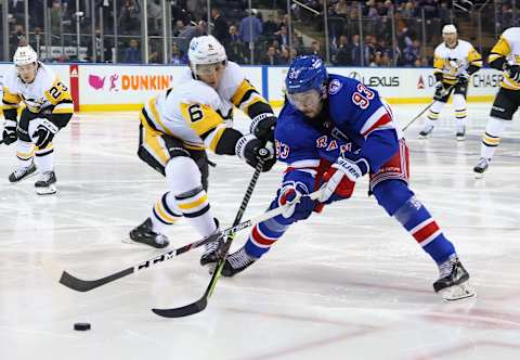 NEW YORK, NEW YORK – MAY 03: John Marino #6 of the Pittsburgh Penguins checks Mika Zibanejad #93 of the New York Rangers in Game One of the First Round of the 2022 Stanley Cup Playoffs at Madison Square Garden on May 03, 2022 in New York City. The Penguins defeated the Rangers 4-3 in triple overtime. (Photo by Bruce Bennett/Getty Images)