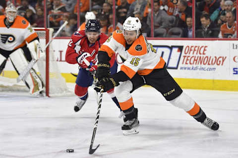 Dec 21, 2016; Philadelphia, PA, USA; Philadelphia Flyers defenseman Michael Del Zotto (15) skates with the puck past Washington Capitals center Evgeny Kuznetsov (92) during the first period at Wells Fargo Center. Mandatory Credit: Derik Hamilton-USA TODAY Sports