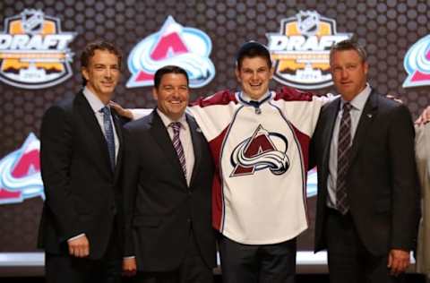 Jun 27, 2014; Philadelphia, PA, USA; Conner Bleackley poses for a photo with team officials after being selected as the number twenty-three overall pick to the Colorado Avalanche in the first round of the 2014 NHL Draft at Wells Fargo Center. Mandatory Credit: Bill Streicher-USA TODAY Sports