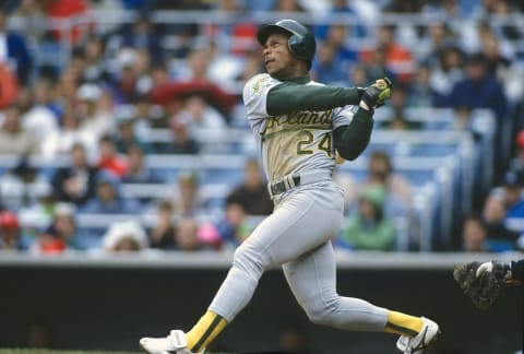 NEW YORK – CIRCA 1992: Outfielder Rickey Henderson #22 of the Oakland Athletics bats against the New York Yankees during an Major League Baseball game circa 1992 at Yankee Stadium in the Bronx borough of New York City. Henderson played for the Athletics from 1979-84, 1989-93,1994-95 and 1998. (Photo by Focus on Sport/Getty Images)