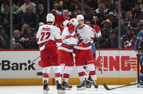 DENVER, COLORADO – DECEMBER 19: Andrei Svechnikov #37 of the Carolina Hurricanes celebrates a goal against the Colorado Avalanche with teammates Warren Foegele #13 and Brett Pesce #22 at Pepsi Center on December 19, 2019 in Denver, Colorado. The Hurricanes defeated the Avalanche 3-1. (Photo by Michael Martin/NHLI via Getty Images)