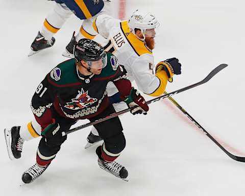 Arizona Coyotes forward Taylor Hall (91) and Nashville Predators defensemen Ryan Ellis (4) lMandatory Credit: Perry Nelson-USA TODAY Sports