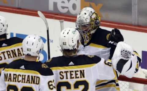 Mar 16, 2021; Pittsburgh, Pennsylvania, USA; Boston Bruins right wing Oskar Steen (62) and goaltender Daniel Vladar (80) celebrate after defeating the Pittsburgh Penguins at PPG Paints Arena. Boston won 2-1. Mandatory Credit: Charles LeClaire-USA TODAY Sports