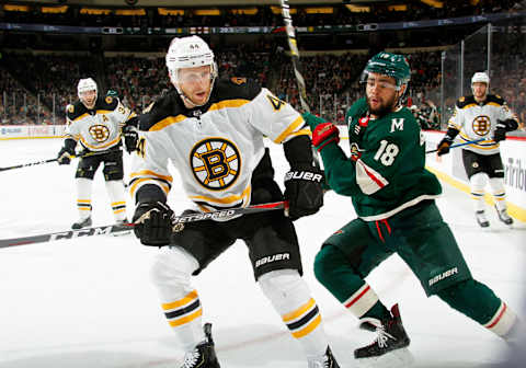 ST. PAUL, MN – APRIL 04: Steven Kampfer #44 of the Boston Bruins and Jordan Greenway #18 of the Minnesota Wild race after a loose puck during a game at Xcel Energy Center on April 4, 2019 in St. Paul, Minnesota.(Photo by Bruce Kluckhohn/NHLI via Getty Images)