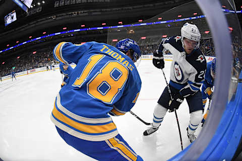 ST. LOUIS, MO – NOVEMBER 24: St. Louis Blues center Robert Thomas (18) and Winnipeg Jets leftwing Nikolaj Ehlers (27) battle on the boards for the puck during a NHL game between the Winnipeg Jets and the St. Louis Blues on November 24, 2018, at Enterprise Center, St. Louis, MO. (Photo by Keith Gillett/Icon Sportswire via Getty Images)