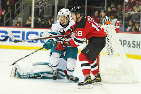 Oct 22, 2022; Newark, New Jersey, USA; New Jersey Devils left wing Ondrej Palat (18) and San Jose Sharks defenseman Matt Benning (5) fight for position during the second period at Prudential Center. Mandatory Credit: Thomas Salus-USA TODAY Sports