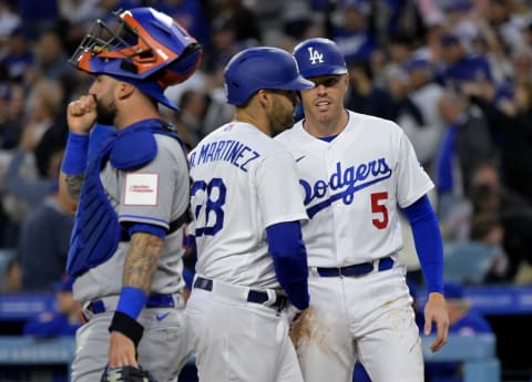 Apr 18, 2023; Los Angeles, California, USA; New York Mets catcher Tomas Nido (3) looks on as Los Angeles Dodgers left fielder J.D. Martinez (28) is greeted by first baseman Freddie Freeman (5) after hitting a two run home run in the first inning against the New York Mets at Dodger Stadium. Mandatory Credit: Jayne Kamin-Oncea-USA TODAY Sports