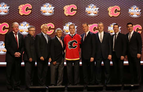 Jun 27, 2014; Philadelphia, PA, USA; Samuel Bennett poses for a photo with team officials after being selected as the number four overall pick to the Calgary Flames in the first round of the 2014 NHL Draft at Wells Fargo Center. Mandatory Credit: Bill Streicher-USA TODAY Sports