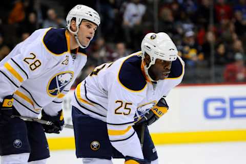 Jan 4, 2010; Denver, CO, USA; Buffalo Sabres center Paul Gaustad (28) and Buffalo Sabres right wing Mike Grier (25) await the start of a face off in the second period against the Colorado Avalanche in the at the Pepsi Center. Mandatory Credit: Ron Chenoy-USA TODAY Sports