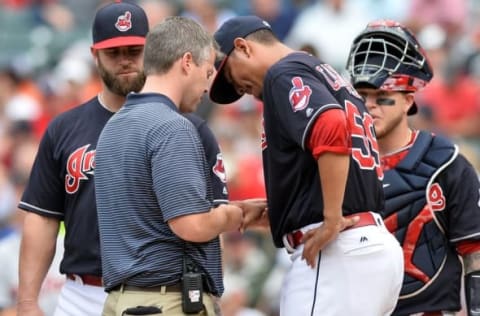 Sep 17, 2016; Cleveland, OH, USA; Cleveland Indians starting pitcher Carlos Carrasco (59) has his hand looked at by trainer James Quinlan after being hit by a batted ball during the first inning against the Detroit Tigers at Progressive Field. Carrasco left the game. Mandatory Credit: Ken Blaze-USA TODAY Sports