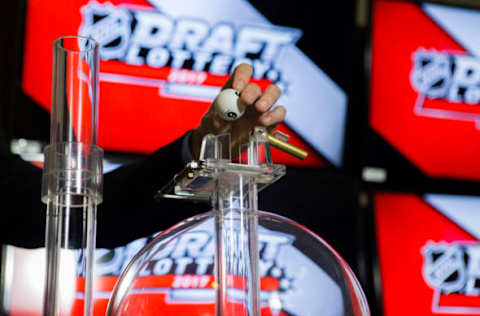 TORONTO, ON – APRIL 29: NHL official loads the lottery ball machine during the NHL Draft Lottery at the CBC Studios in Toronto, Ontario, Canada on April 29, 2017. (Photo by Kevin Sousa/NHLI via Getty Images)